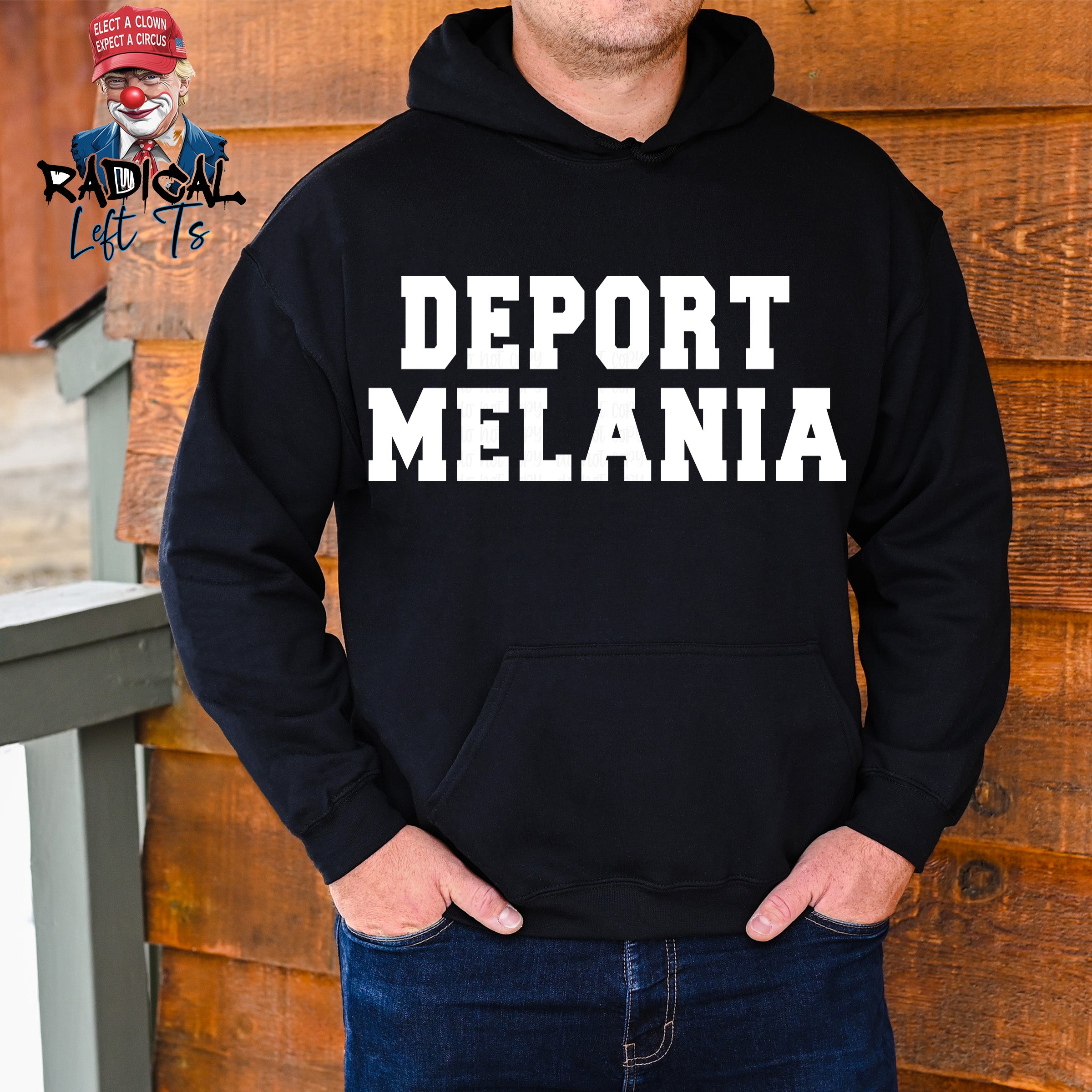 Person wearing a black hoodie with 'DEPORT MELANIA' text against a wooden background.
